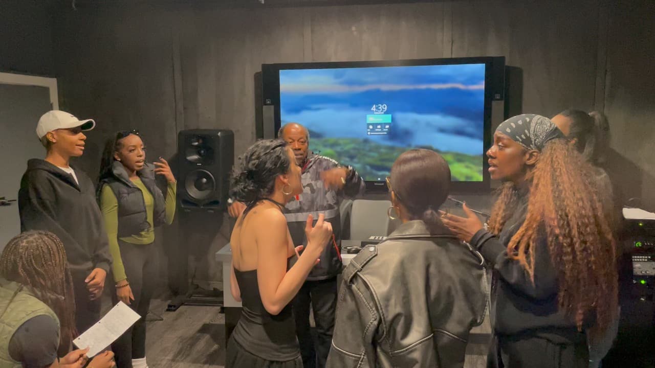 Lawrence Dopson coaching singers in a studio